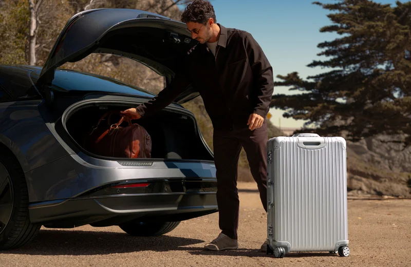 Man putting luggage in the trunk of a Lucid Air