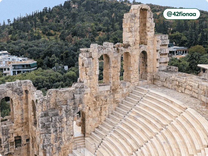 Image description: The ruins of a Roman amphitheater on the grounds of the Acropolis, photo taken by @42fionaa