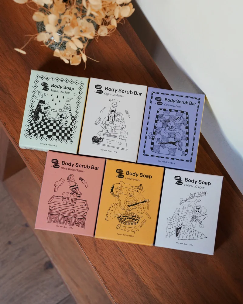 Six soaps are set up in a staggered grid on a wooden bench