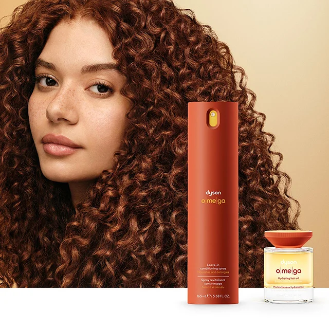 A model with nourished hair behind the Dyson Omega leave-in conditioning spray