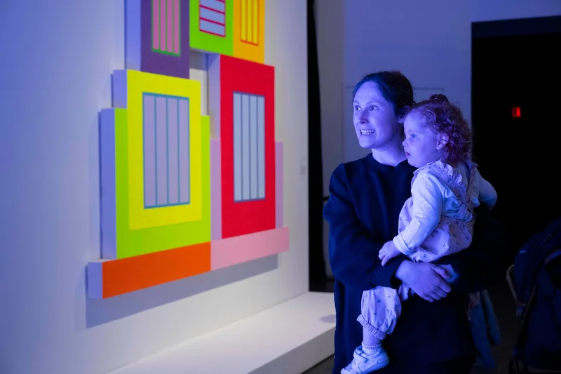 A mother and daughter looking at art