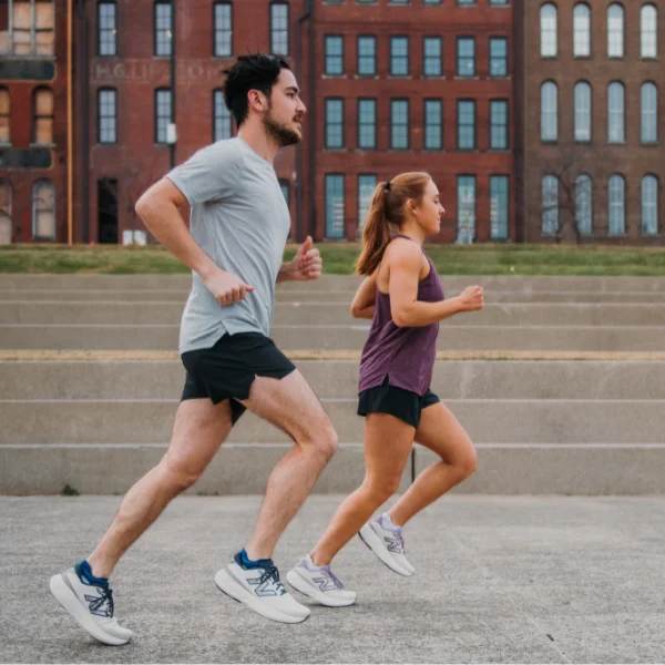 Man and woman running in New Balance gear