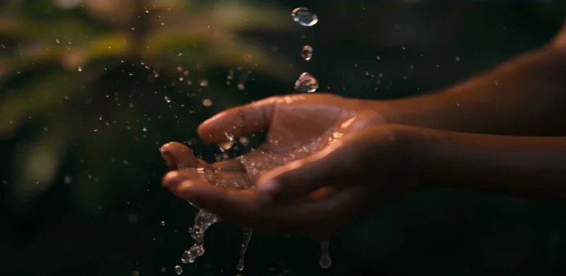 Graphic of of someone washing their hands with clean water.