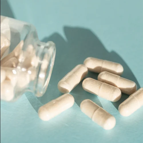 A handful of probiotic pills on a table.