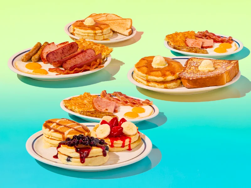The Pancake Flight BreakFEAST, on a light blue to salmon gradient background