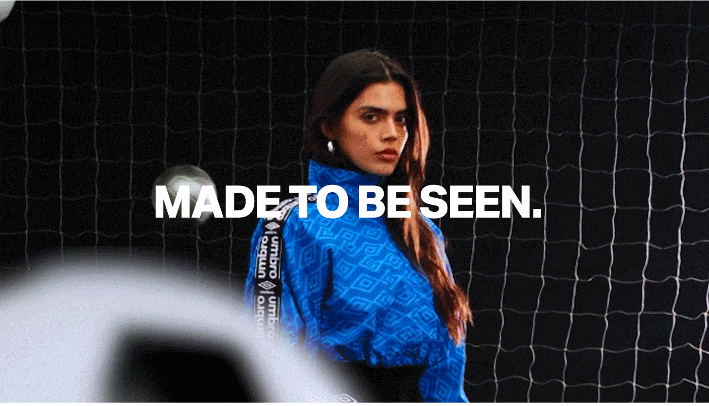 Umbro women's blue patterned jacket, made to be seen. Stylish sportswear for soccer & athletic fashion.
