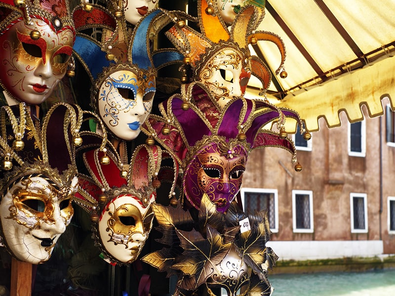 A collection of colorful and intricately designed Venetian carnival masks.