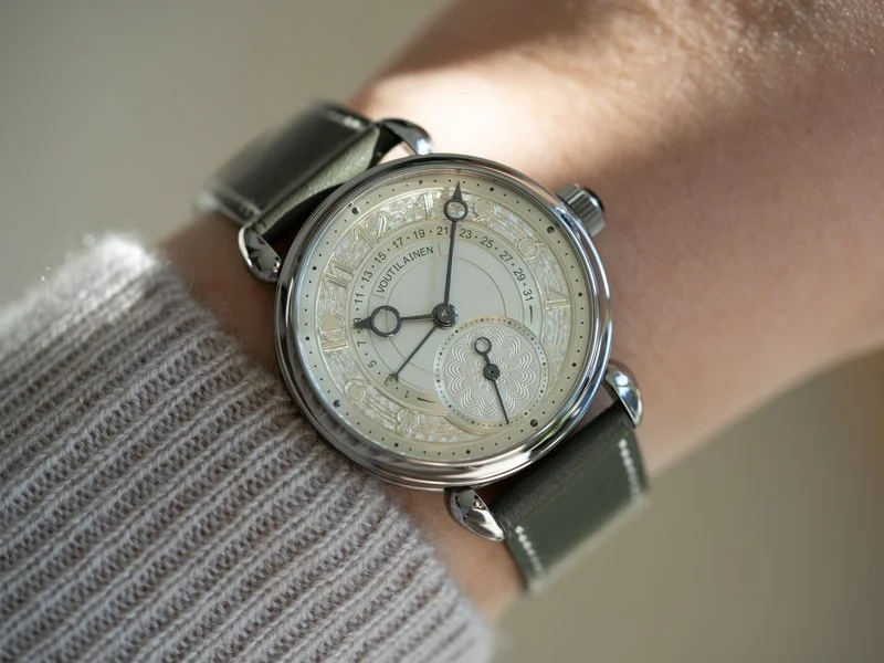 Image may contain: Wristwatch, Arm, Body Part, and Person