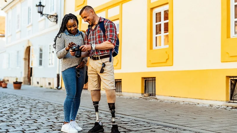 Image description: A couple looking at a camera together while traveling.
