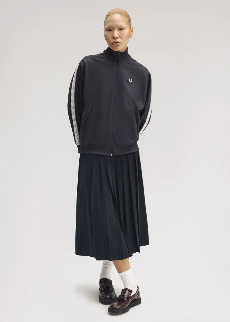 Female model wearing a Taped Track Jacket in Anchor Grey