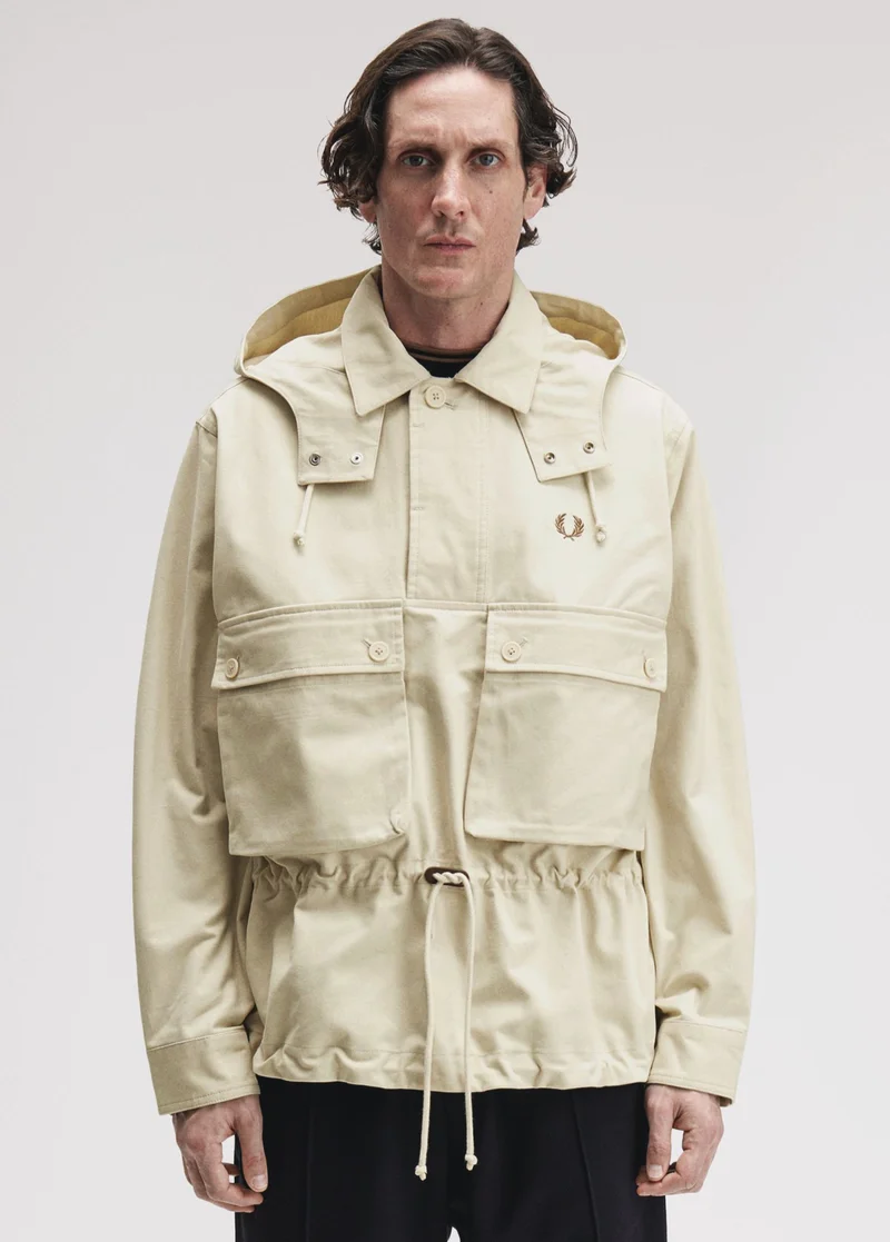 Male model wearing a Fred Perry Coaches Smock Jacket in Oatmeal