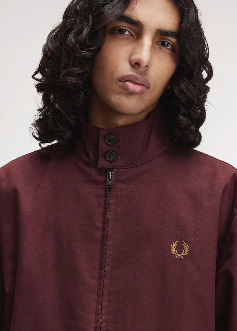 Model wearing a Fred Perry Classic Harrington Jacket in Oxblood
