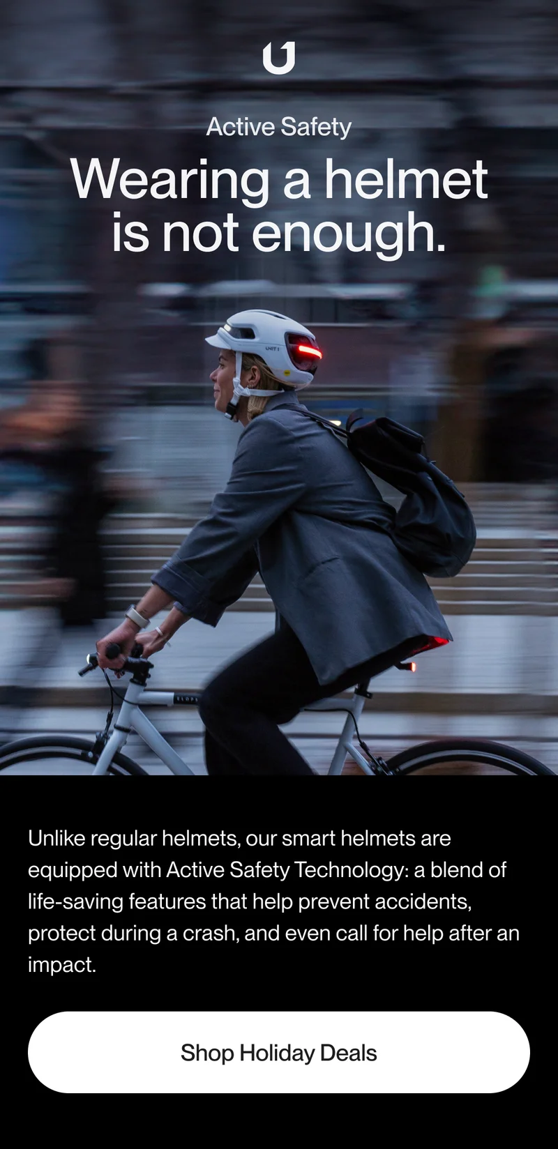 Man wearing a bike helmet with integrated lights.