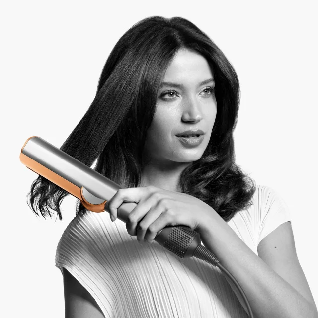 Model using the Dyson Airstrait straightener