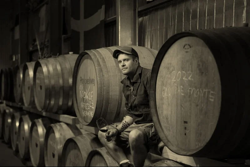 Black and white photo of Poppelvej winemaker Uffe Deichmann in the barrel hall.