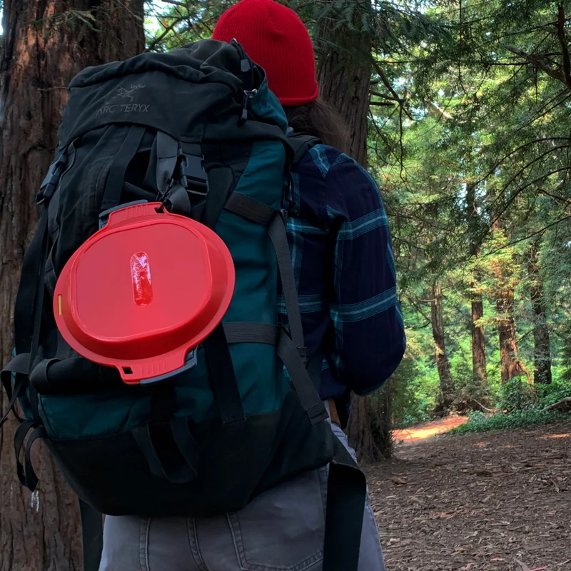 A camper with a GoKit hanging from their backpack.