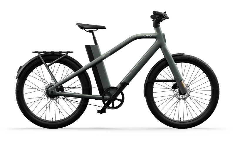 A render. Side view of a green Cowboy Cross e-bike with a cargo rack and minimalist design.