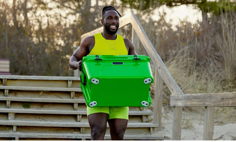 Coach Ackeem hitting the beach with a cooler.