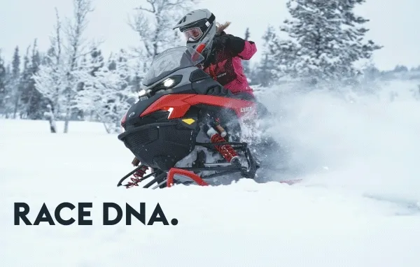 Riders in the snow on Lynx Rave sleds