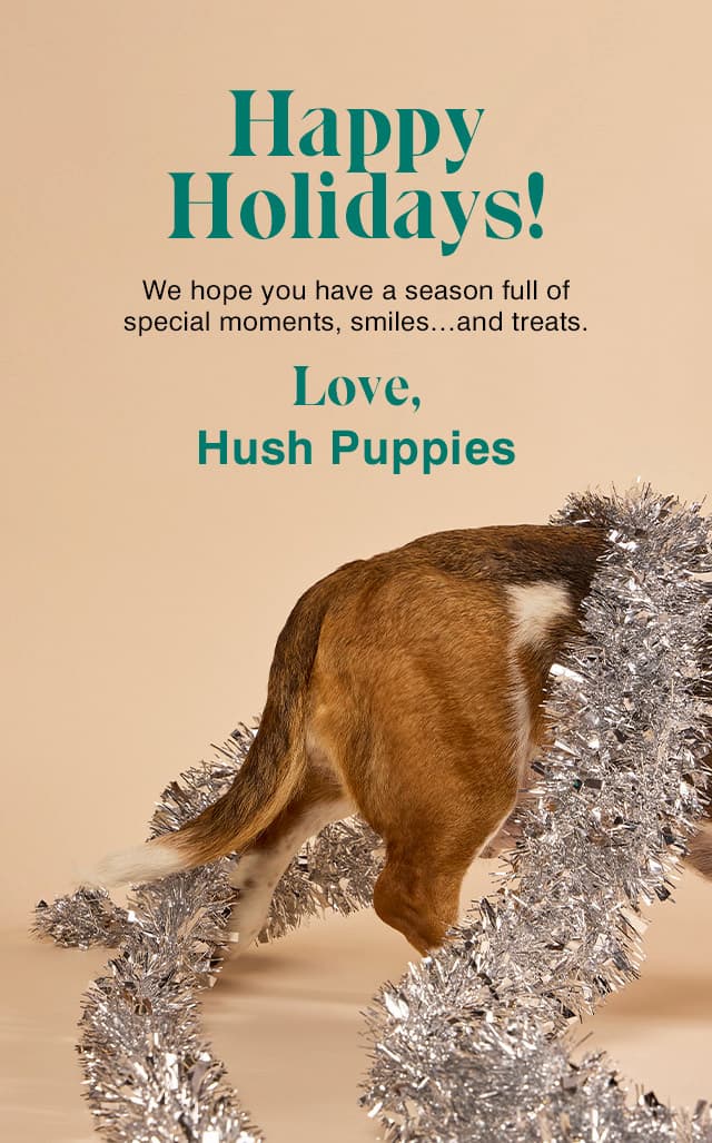 A light yellow background with a basset hound wearing silver tinsel garland.