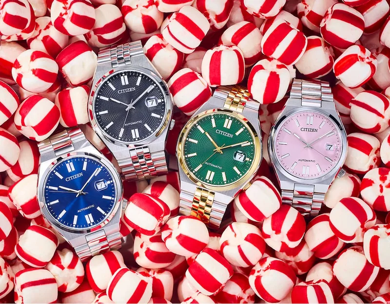 Four watches nestled in a bed of striped peppermint candies