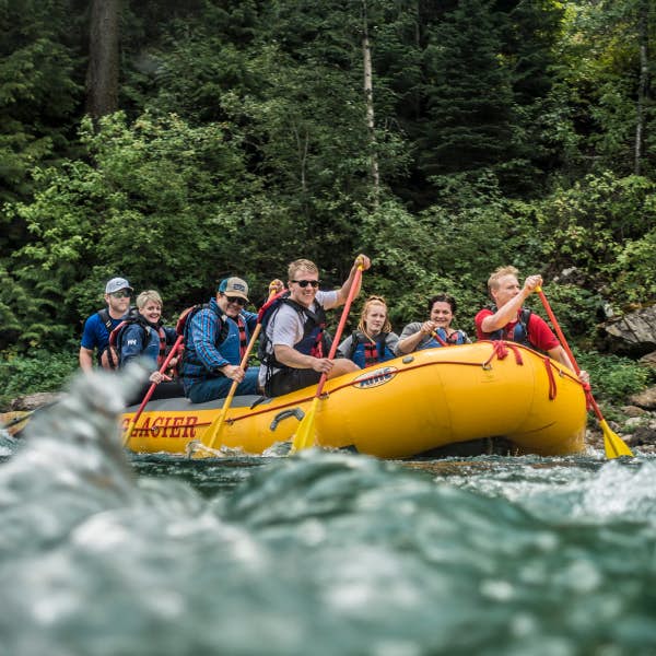 A group of people white water rafting