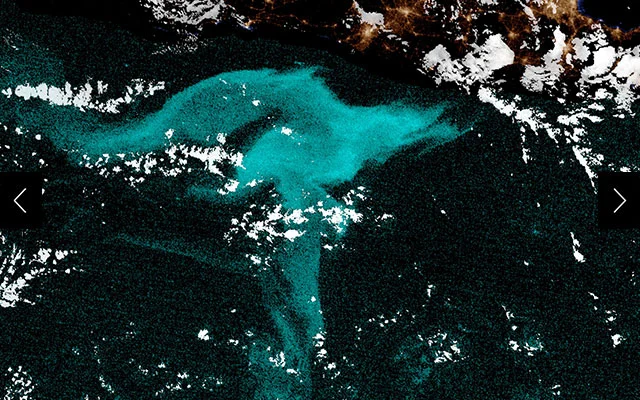 Satellite imagery of visible light for a nighttime scene near Java, Indonesia collected by the National Oceanic and Atmospheric Administration. Highlighted in blue, the image shows what scientists think to be a 38,000 square foot milky seas incident.