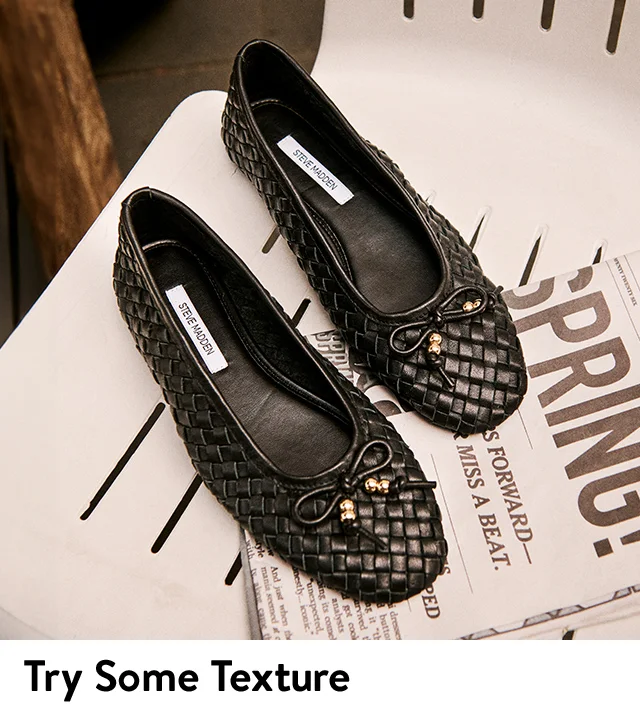 A pair of black woven flats.