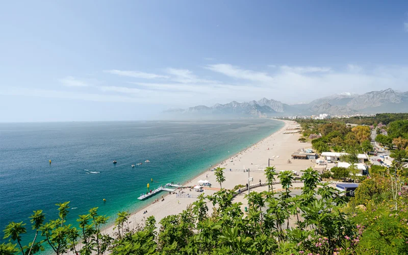 Konyaalti Beach Park is shaded by palm trees and popular with locals.