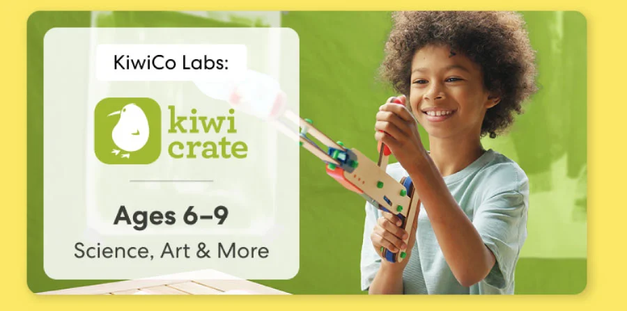 Young girl smiling while working on a science experiment from KiwiCo Labs. Hands-on STEM learning for ages 6–8.