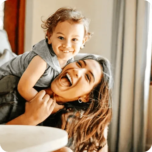 A smiling mom playing with her little boy A smiling mom playing with her little boy