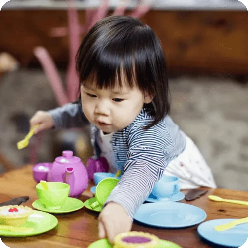 a toddler pretend playing with a tea set a toddler pretend playing with a tea set