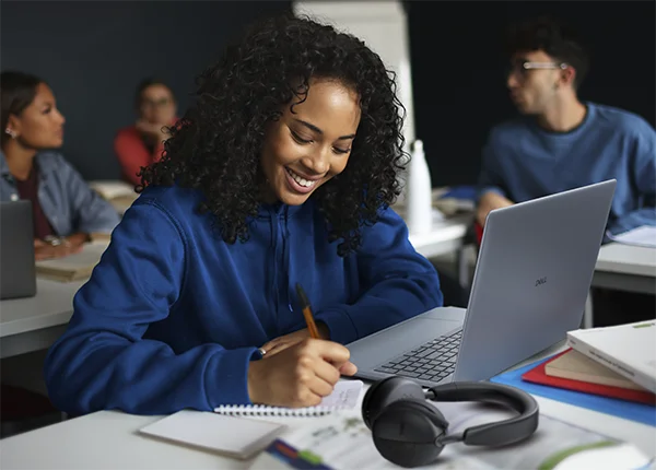 Students attending a lesson, sitting at their desks, in a classroom.
