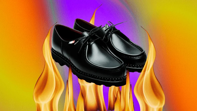 A pair of black Paraboot Michael mens shoes photoshopped over flames and a swirling background
