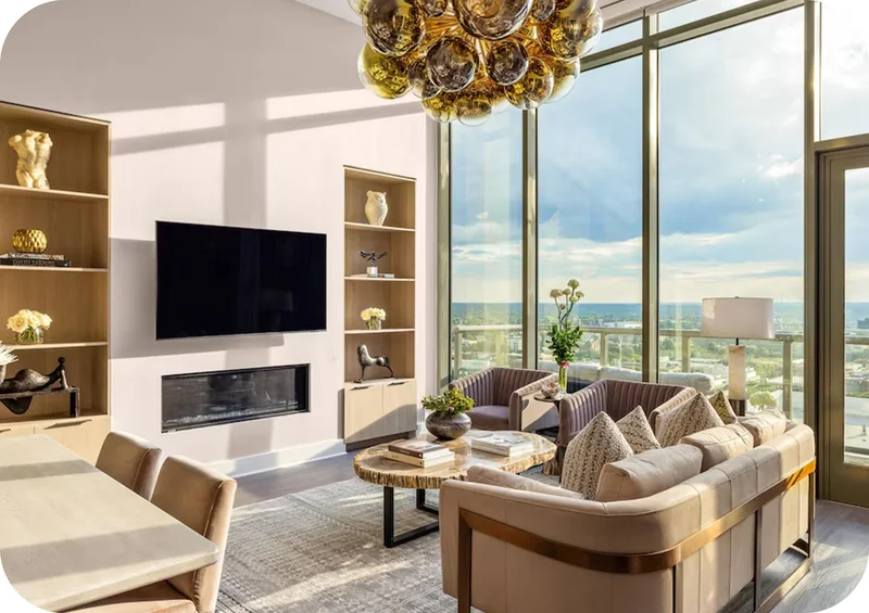 Sunlit modern living room with floor‑to‑ceiling windows and stylish neutral décor.