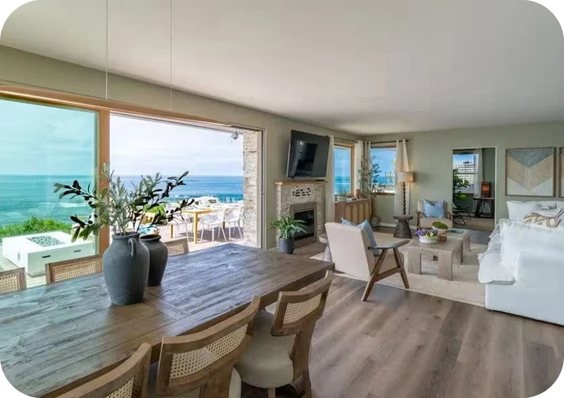 Open dining area with ocean views, wooden table, and coastal décor.