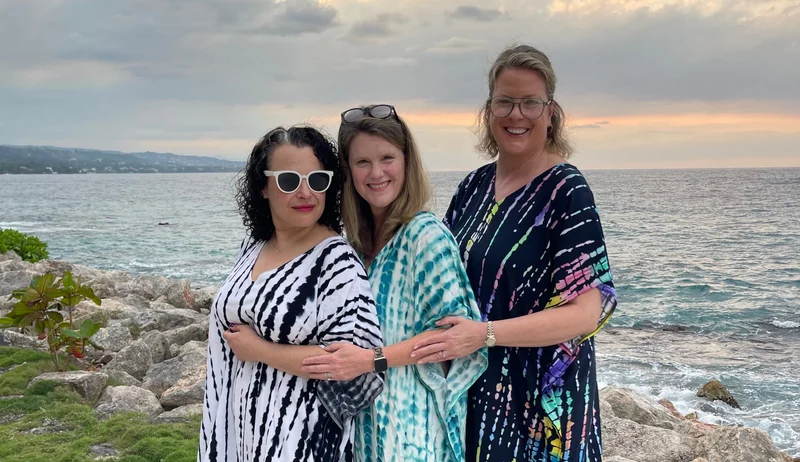 Brekke and friends pose at GoldenEye wearing their caftans