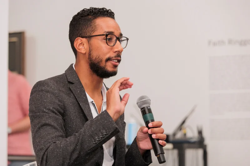A person speaking at a microphone