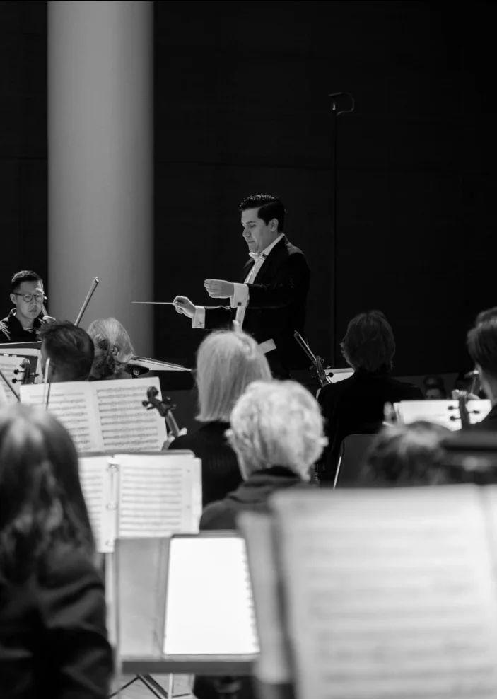 A conductor leading an orchestra