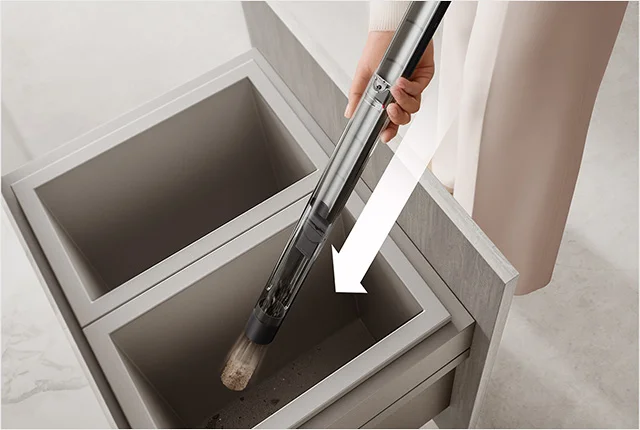 The Dyson PencilVac emptying into a bin
