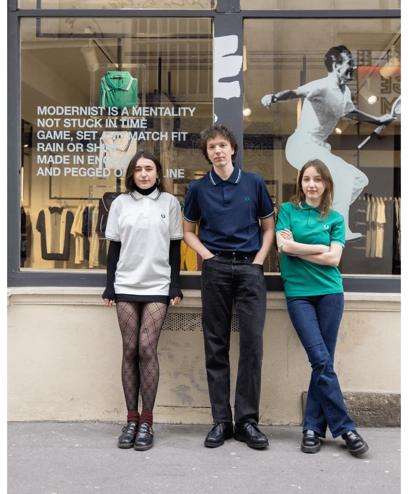 3 Fred Perry retail workers (1 man, 2 women) standing outside the Fred Perry Paris store