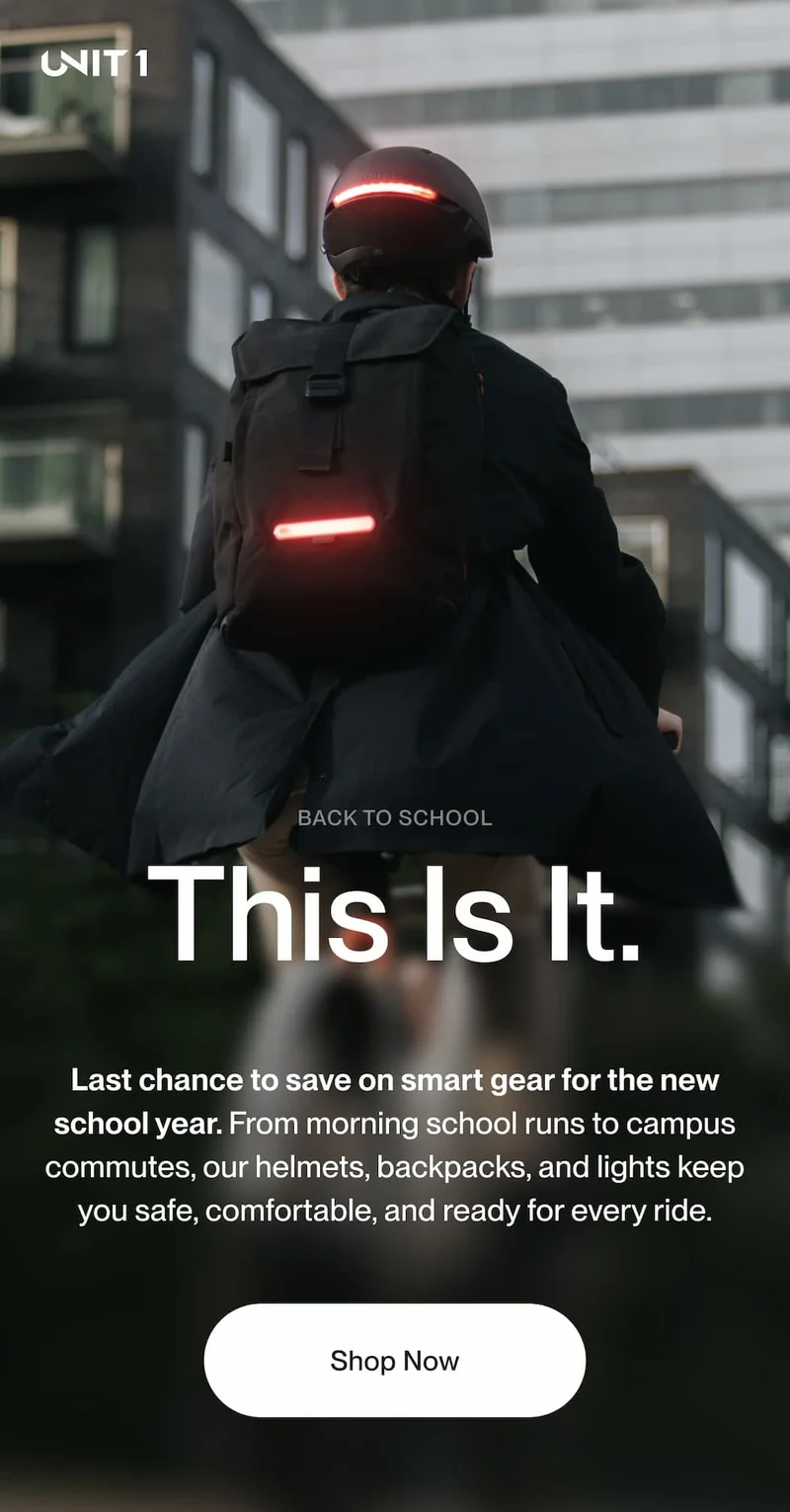 Cyclist wearing a UNIT 1 smart helmet and TORCH backpack with integrated lights, promoting Back to School sale.