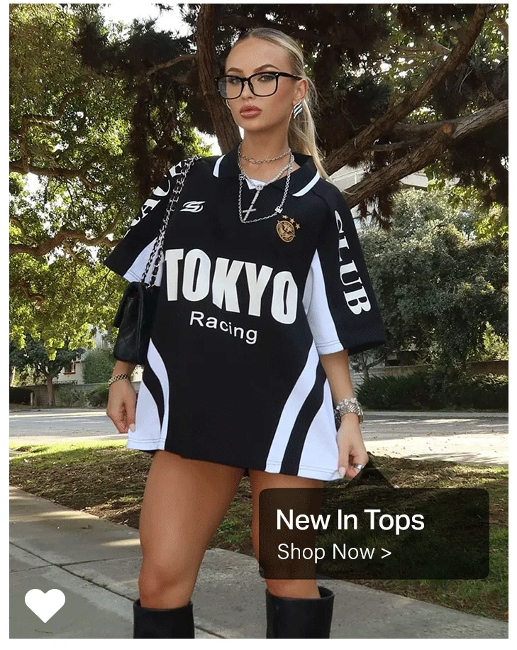 Stylish woman in a new black and white "Tokyo Racing" oversized tee and glasses, showcasing new casual tops available now.
