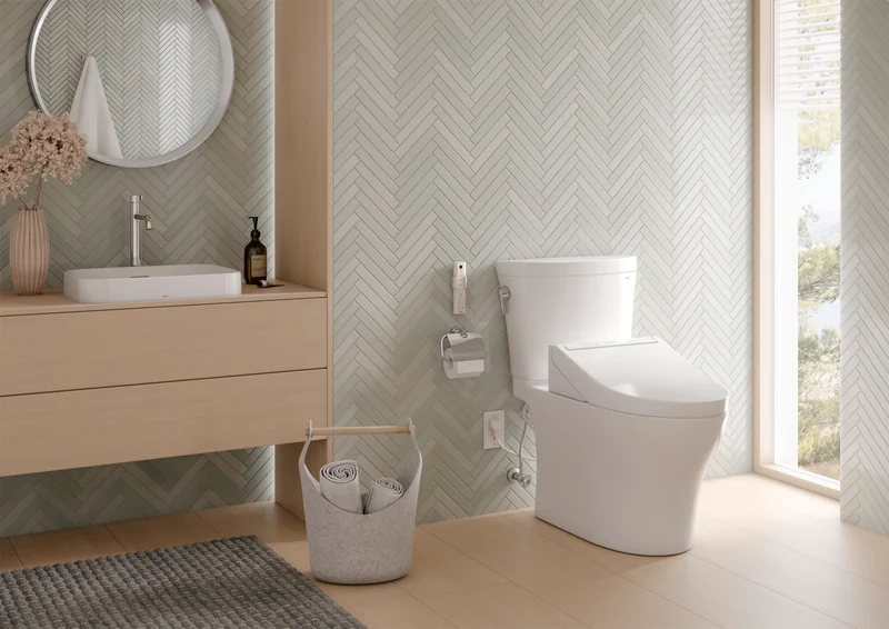 A Soiree WASHLET+ S7 bidet toilet in a sunlit bathroom with a lush green landscape visible through the bathroom window
