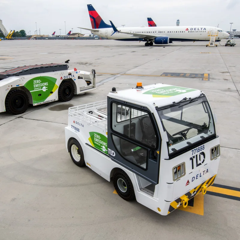 Delta electric ground support with a Delta plane in the background