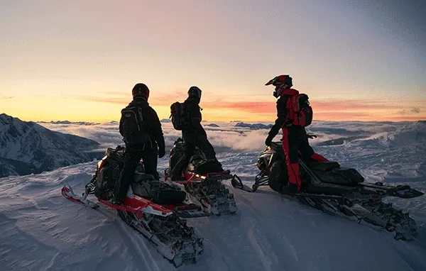 Riders on Lynx sleds in the snow