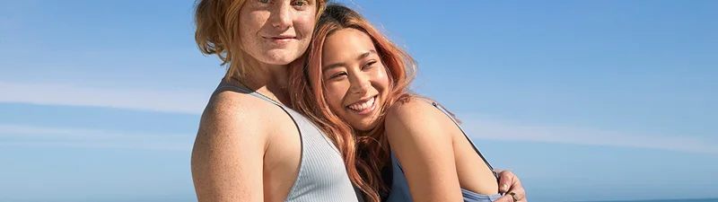 Two women hugging each other