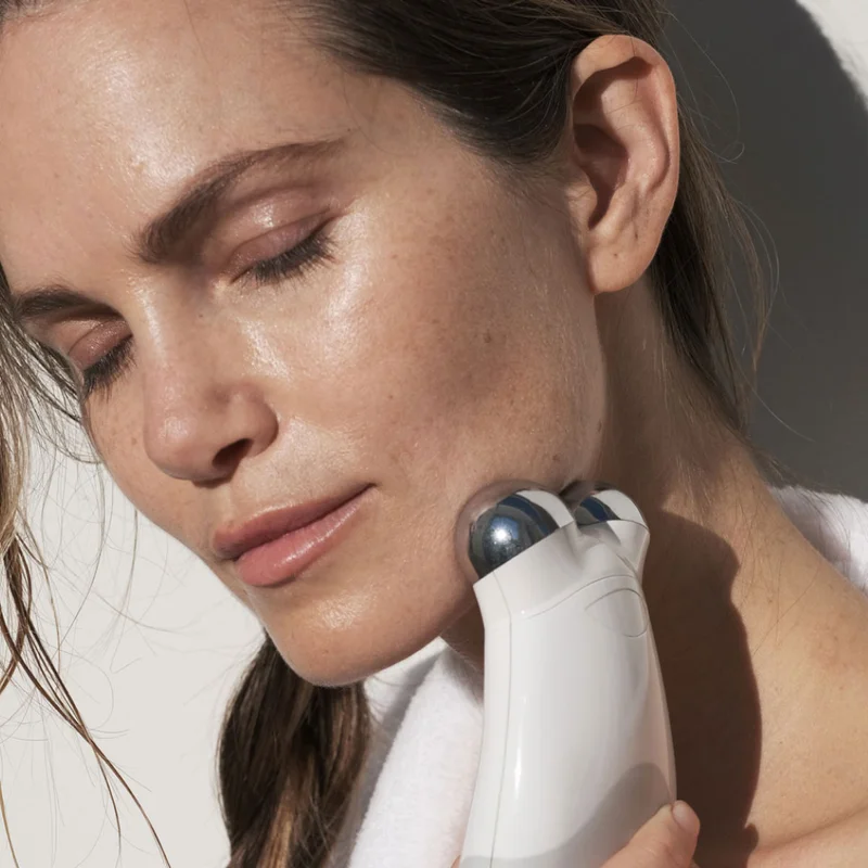 Woman gliding NuFACE Trinity along jawline