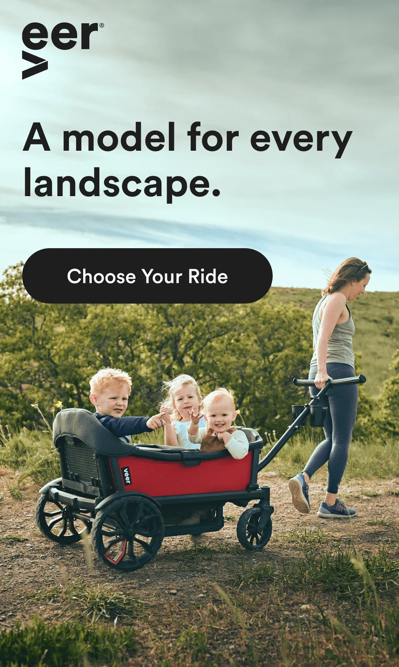A woman pulling a Cruiser with her children over a dirt path