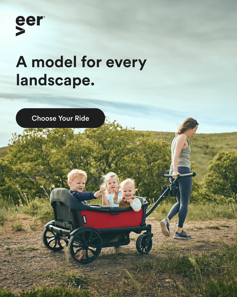 A woman pulling a Cruiser with her children over a dirt path